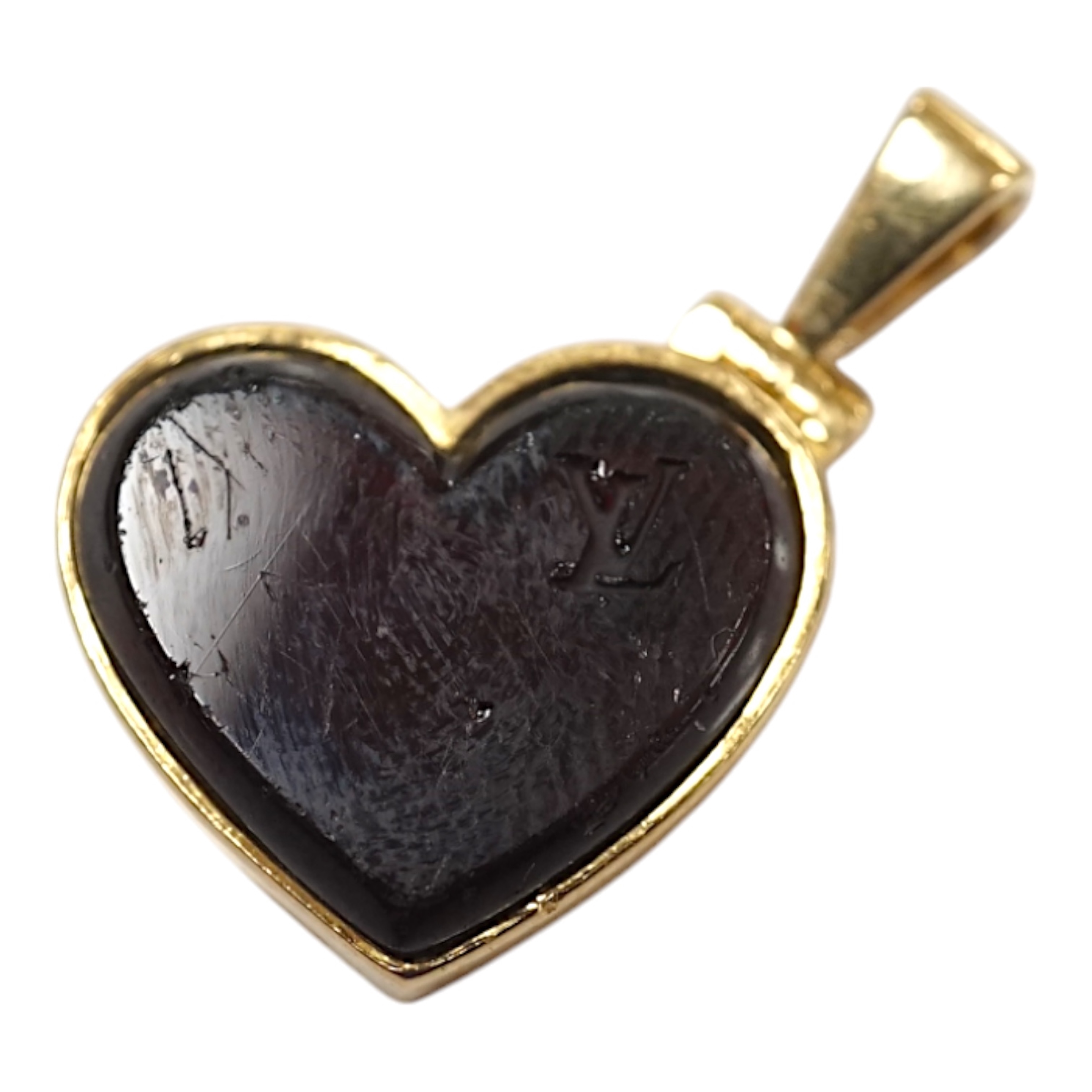 A modern Louis Vuitton 750 yellow metal and garnet? set heart shaped locket, width 15mm, gross weight 5.9 grams. Condition - poor to fair